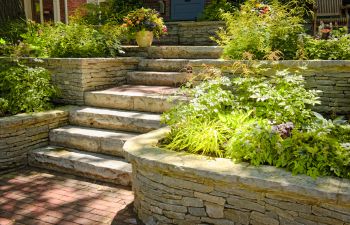 natural stone steps and retaining walls in the front yard